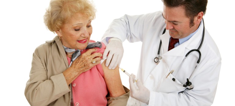 senior woman receiving a flu shot