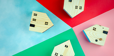 four miniature wooden toy houses