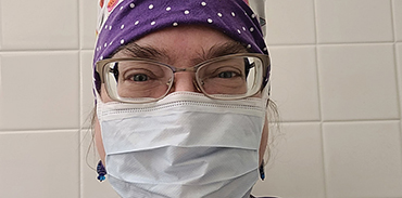 Dr. Margaret Fraser wearing a scrub cap and mask