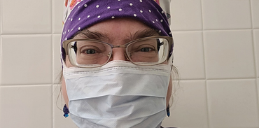 Dr. Margaret Fraser wearing scrub cap and mask