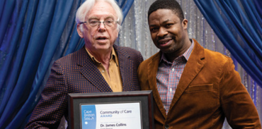 Dr. James Collins receiving an award from Dr. Tobechi Okeke