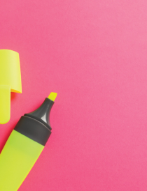 yellow highlighter with cap removed on a pink background