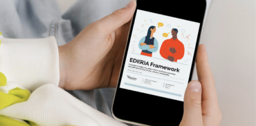 person holding a phone and looking at a digital copy of the EDI(R)A Framework document
