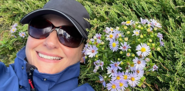 Dr. Irina Ghenea laying in a field of flowers