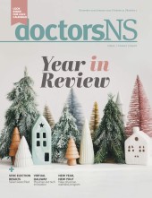 Miniature cozy village with ceramic houses, wooden christmas treeson the cover of the December/January 2022 issue of the doctorsNS magazine