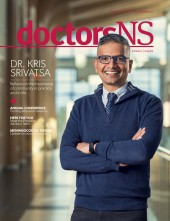 Dr. Alison Wellwood wearing navy sweater and pants with white shirt and tie on the cover of the April 2023 edition of the doctorsNS magazine