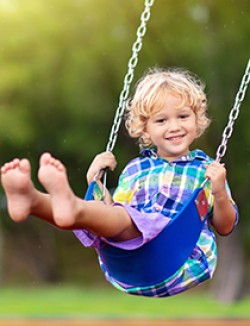 Child on playground swing
