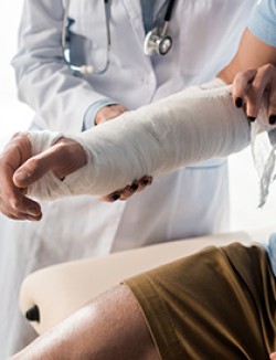 Physician examining an arm cast