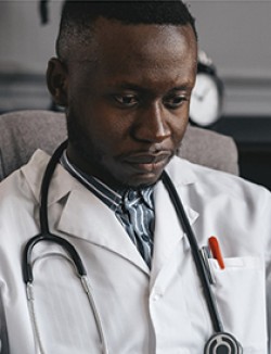 Physician wearing lab coat with stethoscope around his neck