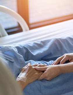holding hands at hospital bedside