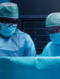 Two masked physicians in the operating room