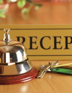bell and keys on hotel reception desk
