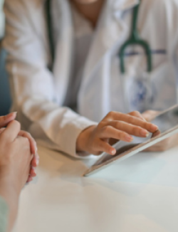 physician using a tablet to share information with a patient