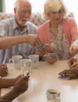 group of older persons playing cards
