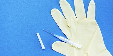 Surgical glove and syringe