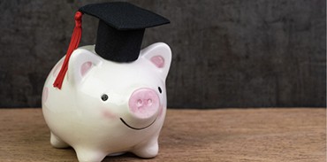 Piggy bank wearing a graduation cap