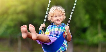 Child playing on a swing