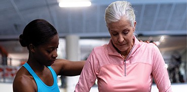 Young woman giving assistance to an older woman