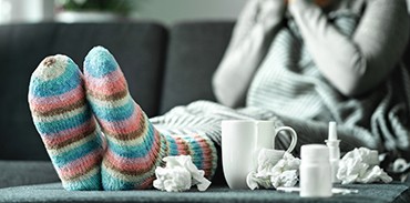 woman with feet up and feeling ill