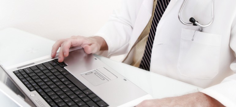 Doctor working on a laptop.