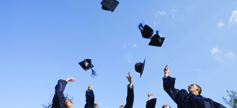 Graduates tossing caps
