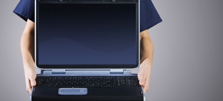 Doctor holding a laptop.