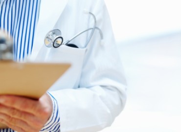 physician taking notes on a clipboard