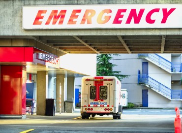 image of an ambulance at a hospital emergency entrance