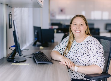 image of DNS president, Dr. Leisha Hawker sitting at a desk