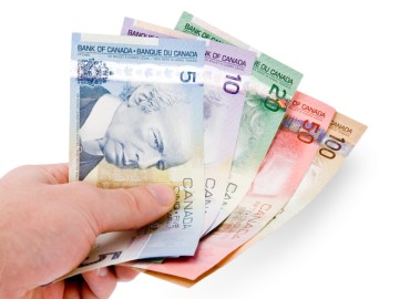Canadian paper currency held in a hand