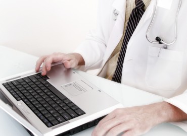 Doctor working on a laptop.