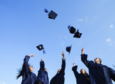 Graduates tossing caps