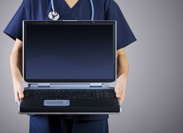 Doctor holding a laptop.