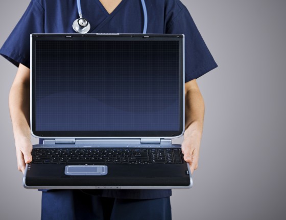 Doctor holding a laptop.
